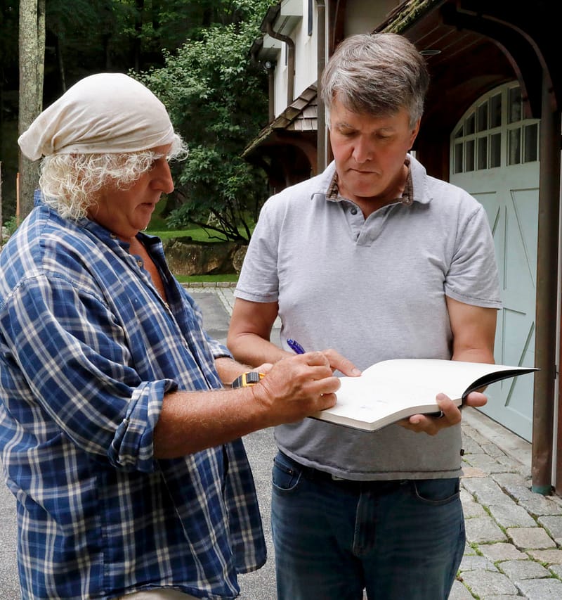 Gavin Johnston discussing plans with a stone builder