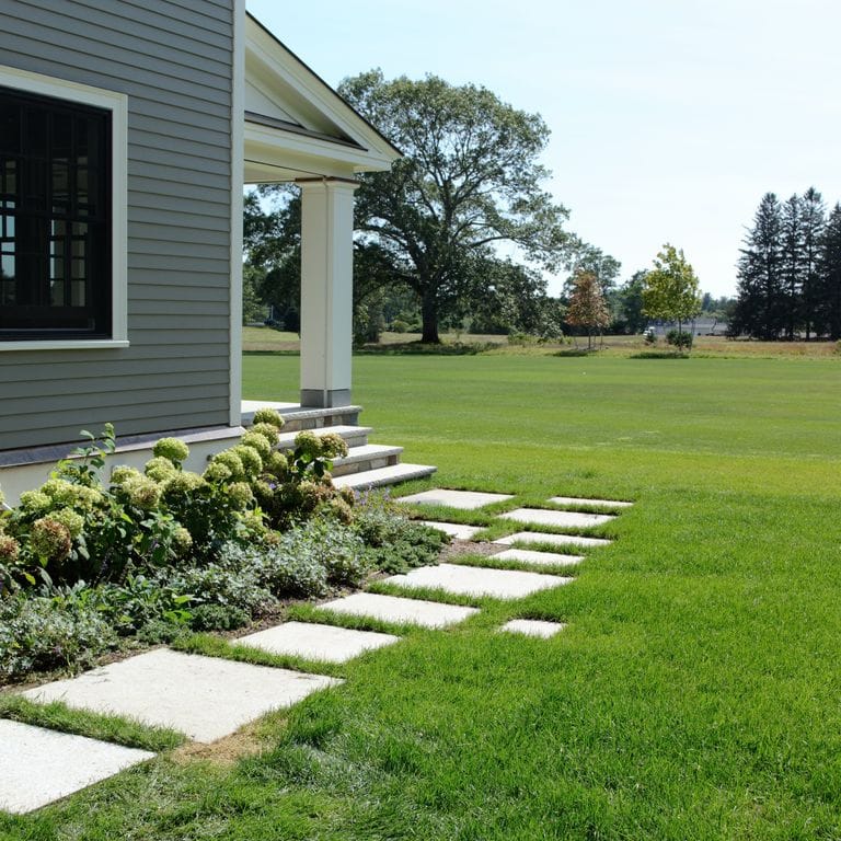 The image shows this material being used in a path pavers application. Dominant colors shown are blue and gray.