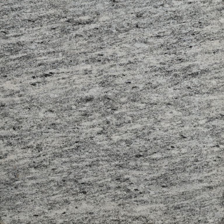 Color/Finish variation image for Brazilian Lucerna Gneiss. The surface finish shown is sand blasted. The dominant color shown is gray. The color mix creates a cool feeling.