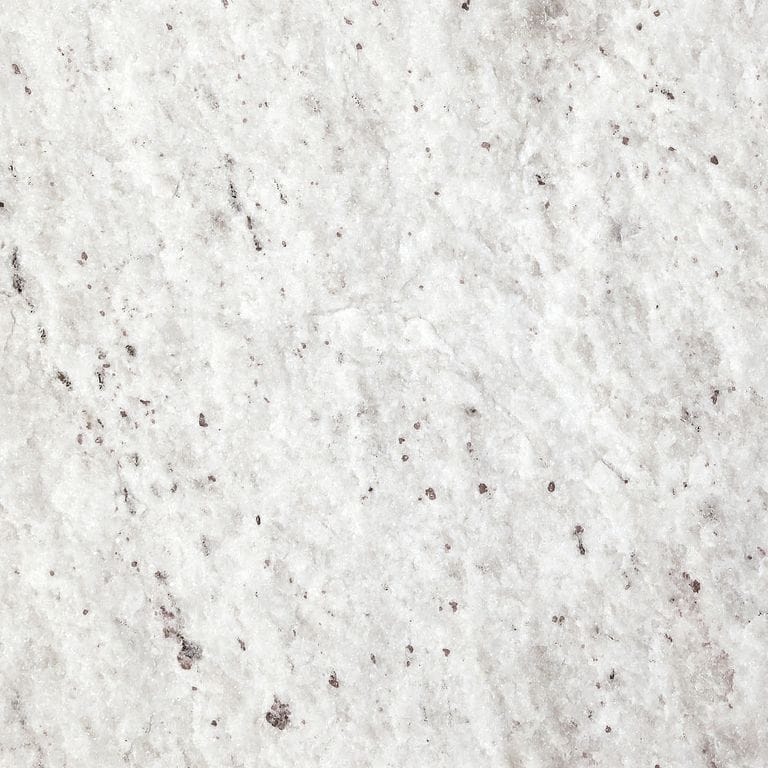 Best close-up image for Gneiss - Yellow Grumari. The surface finish shown is natural cleft. The dominant color shown is white; with beige, white and cream secondaries. The color mix creates a warm feeling. Cloudy color pattern. Contains some mica and mineral inclusions.