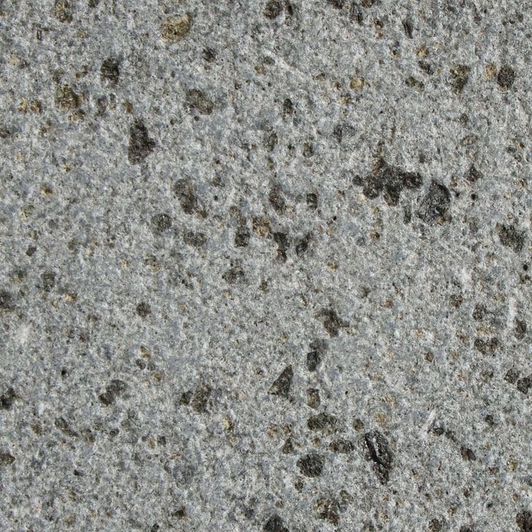 Color/Finish variation image for Basalto Basalt. The surface finish shown is sand blasted. The dominant color shown is gray; with beige, blue, brown, green, purple and white secondaries. The color mix creates a cool feeling. Solid color pattern.