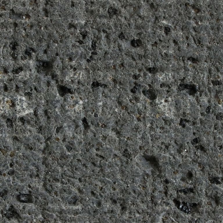Best close-up image for Basalt - Basalto. The surface finish shown is canvas. Dominant colors shown are black and gray; with green and purple secondaries. The color mix creates a cool feeling. Regular color pattern.