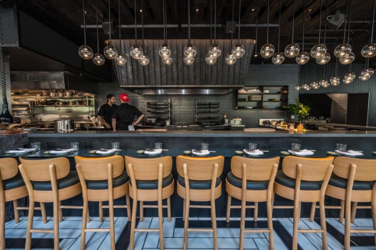 Application image for Basalt - Basalto. The image shows this material being used for architectural elements and countertop slabs. The dominant color shown is black.