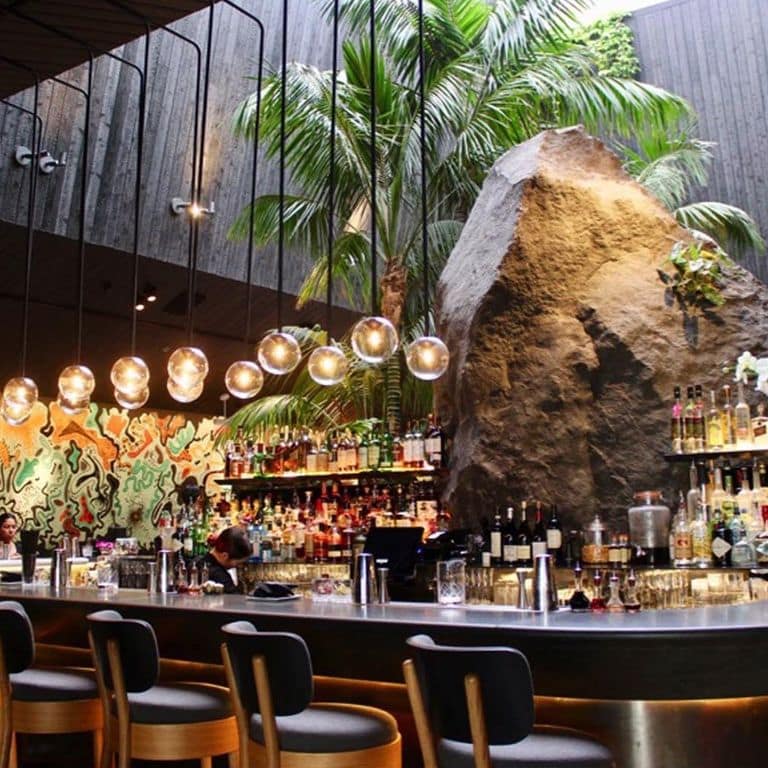 Application image for Basalt - Basalto. The image shows this material being used for architectural elements and countertop slabs. The dominant color shown is black.