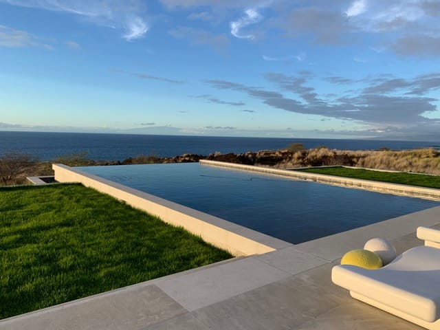 Application image for Fossil Gray Limestone. The image shows this material being used for pool coping and pool deck pavers. The dominant color shown is gray. The color mix creates a cool feeling.