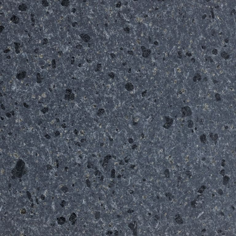 Feature image for Deep Gray Basalt. The surface finish shown is honed. Dominant colors shown are blue and gray; with black, brown, green and purple secondaries. The color mix creates a cool feeling. Fine speckled color pattern. Contains voids.