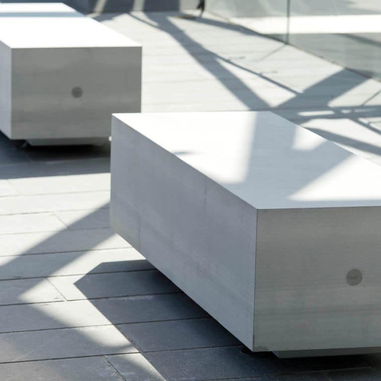 Application image for Pietra Forte Fiorentina Sandstone. The image shows this material being used for seating &amp; benches and interior floor. The surface finish shown is honed. Dominant colors shown are blue, green and gray. The color mix creates a cool feeling. Regular color pattern.