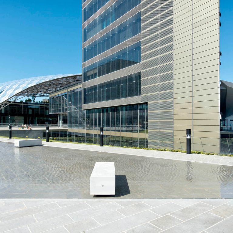 Application image for Pietra Forte Fiorentina Sandstone. The image shows this material being used for water features, seating &amp; benches and patio pavers. The surface finish shown is honed. Dominant colors shown are blue, gray and pink; with beige, white and cream secondaries. The color mix creates a cool feeling. Regular color pattern.