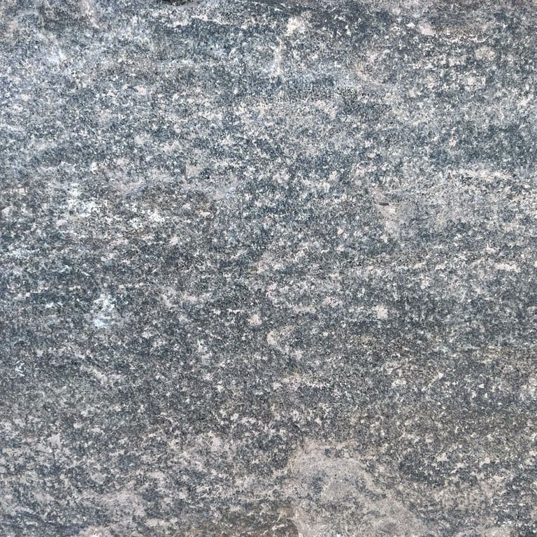 Swatch image for Reclaimed Quartzite Plank Pavers - Blue/Gray. The surface finish shown is a combination of split-face with flat plane, weathered and worn. The dominant color shown is gray; with blue, brown, green, purple and white secondaries. The color mix creates a cool feeling. Regular, fine speckled and random color patterns. Contains some mica.