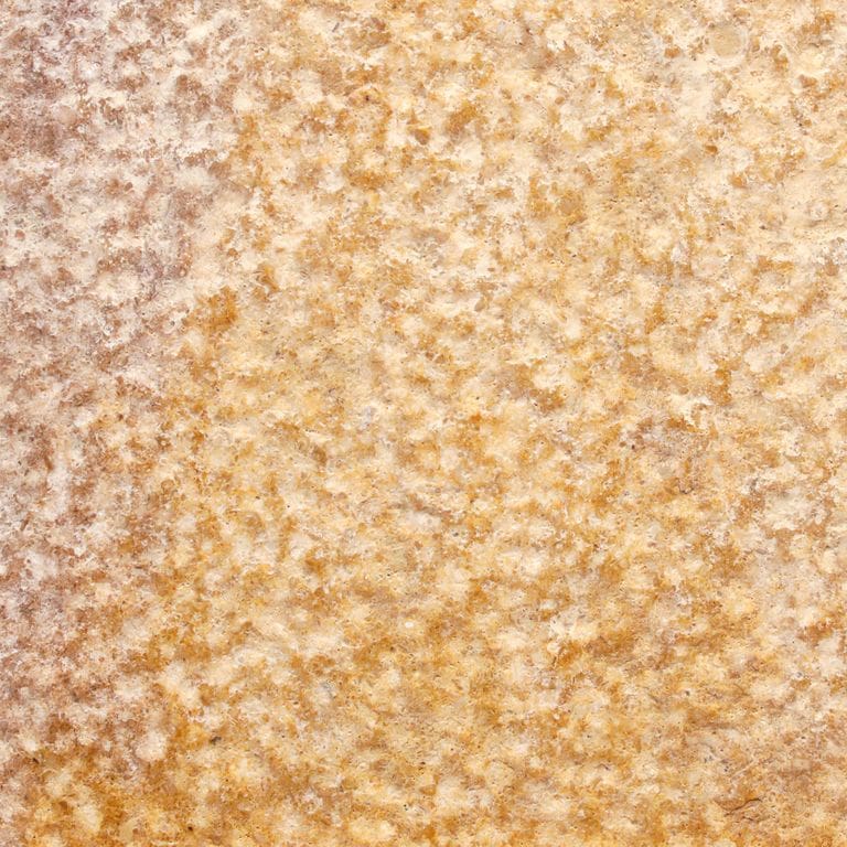 Color/Finish variation image for Golden Sinai Marble. The surface finish shown is a combination of brushed and bush hammered. Dominant colors shown are beige, orange/rust and tan. The color mix creates a warm feeling. Random color pattern.