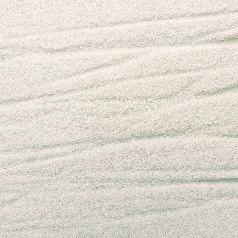 Feature image for Variegated Limestone. The surface finish shown is a combination of grooved and sand blasted. Dominant colors shown are beige, gray, white and cream. The color mix creates a warm feeling. Regular color pattern.