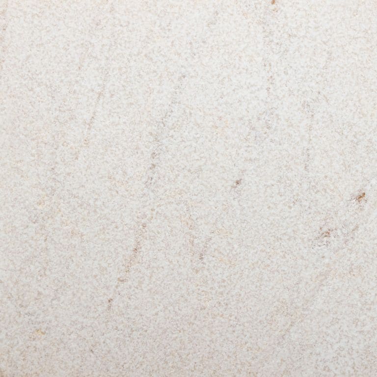 Feature image for Pearl Cream® Marble. The surface finish shown is sand blasted. The dominant color shown is gray. Exhibits "movement" and the color mix creates a warm feeling. Linear and fine speckled color patterns.