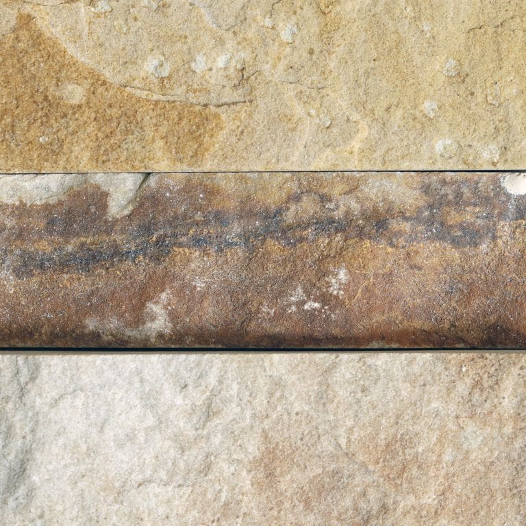 Feature image for Harvest Gold Sandstone. The surface finish shown is a combination of natural and split-face. Dominant colors shown are beige, orange/rust and tan. The color mix creates a warm feeling. Streaked and random color patterns.