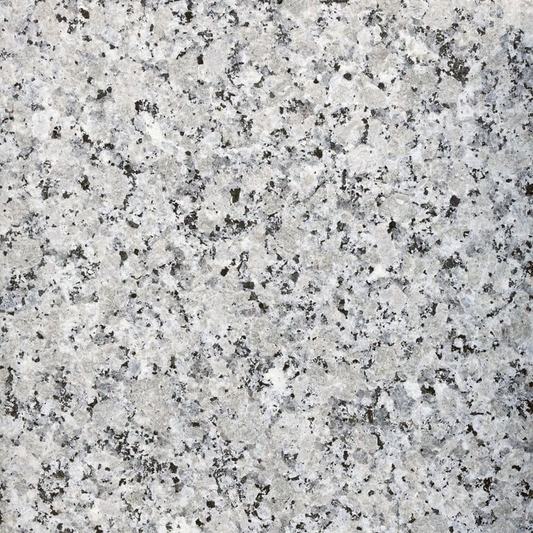 Feature image for Coral Gray Granite. The surface finish shown is flamed. Dominant colors shown are gray and white. The color mix creates a cool feeling. Coarse speckled color pattern.