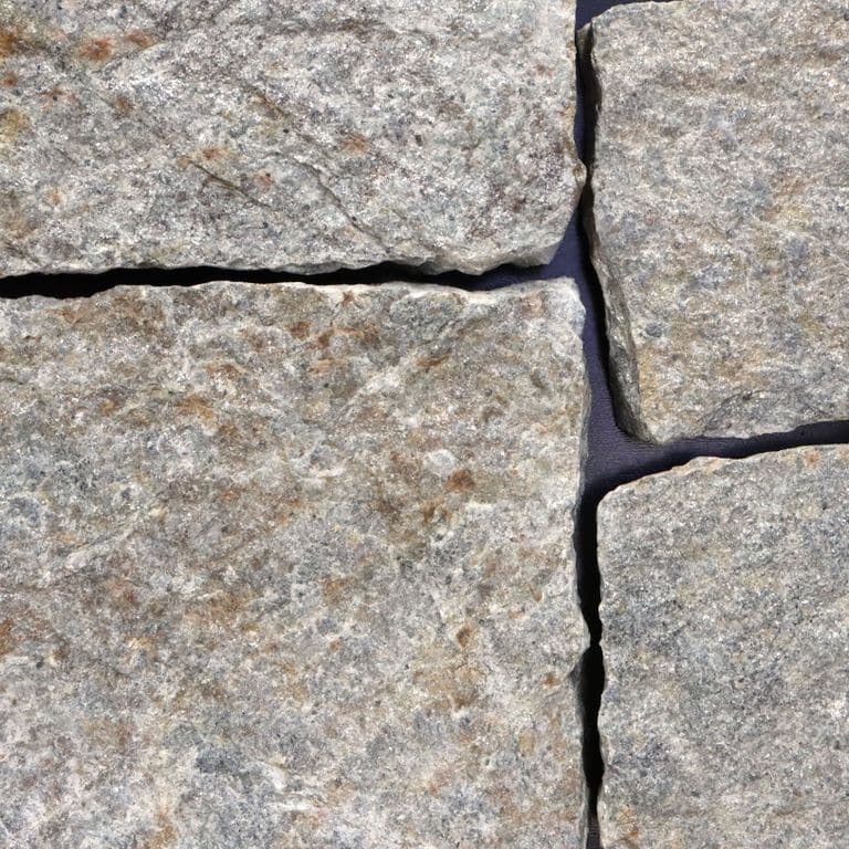 Feature image for Quaker Hill Gray Granite. The image shows this material being used in a thin veneer application. The surface finish shown is . The dominant color shown is gray. The color mix creates a warm feeling. Regular and cloudy color patterns.