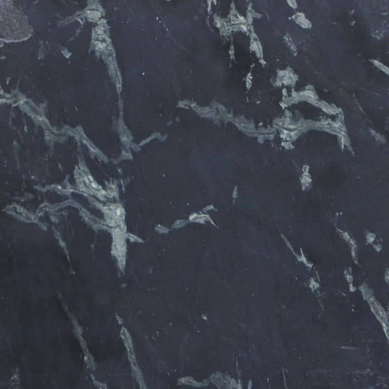 Feature image for Aqua Grantique Gneiss. The surface finish shown is honed. Dominant colors shown are black and purple. Exhibits "movement" and the color mix creates a cool feeling. Swirled color pattern.