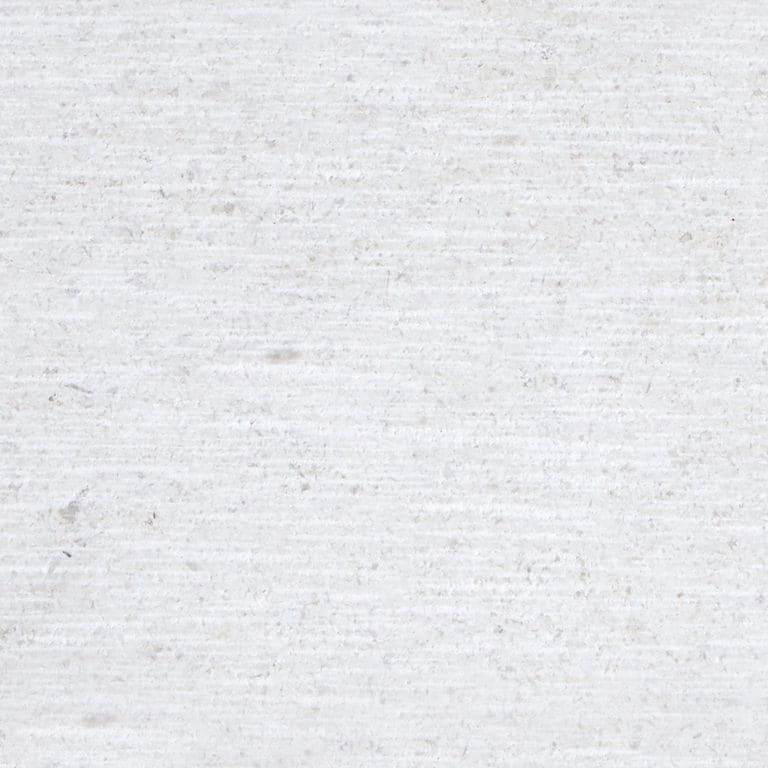 Best close-up image for Fino Limestone. The surface finish shown is scratched. Dominant colors shown are gray, white and cream. The color mix creates a cool feeling. Solid color pattern.