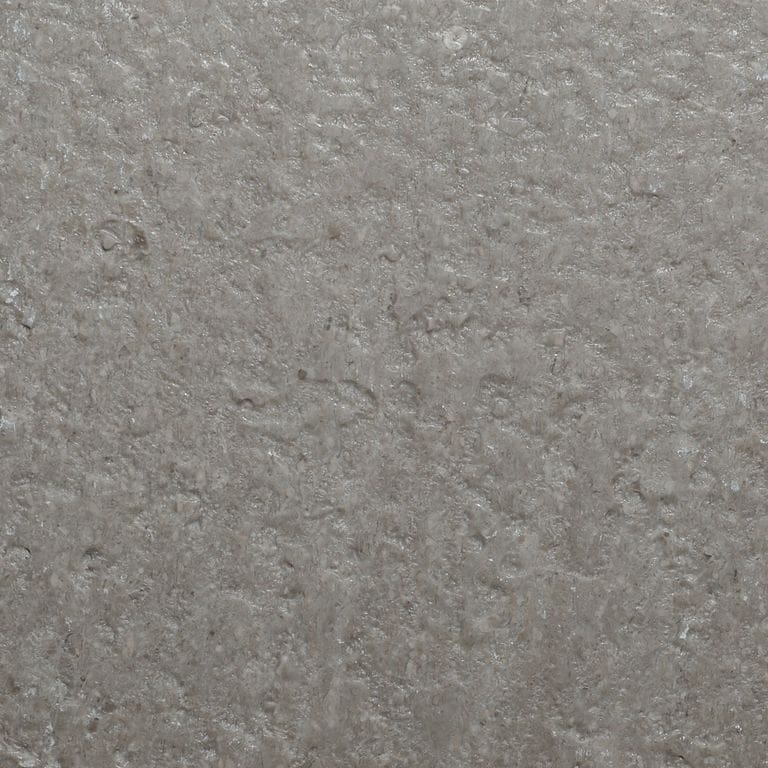 Color/Finish variation image for Northern Bay Limestone. The surface finish shown is acid washed. Dominant colors shown are gray and tan. The color mix creates a cool feeling.