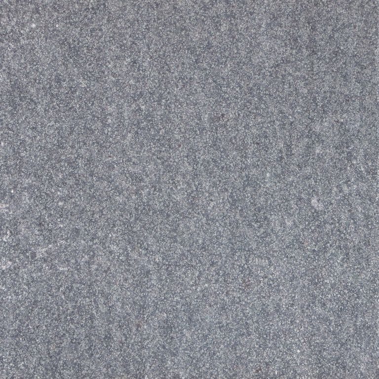 Best close-up image for Flor De Camomila. The surface finish shown is flamed. Dominant colors shown are blue and gray. The color mix creates a cool feeling. Fine speckled color pattern.