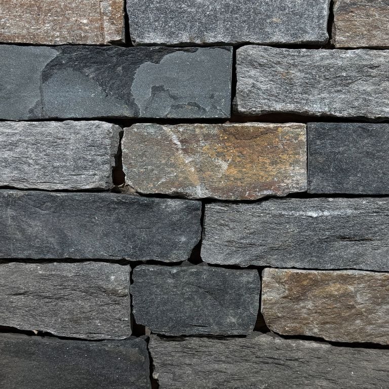 Color/Finish variation image for Vermont Granite Blend. The surface finish shown is split-face. Dominant colors shown are brown, gray and tan. The color mix creates a warm feeling.