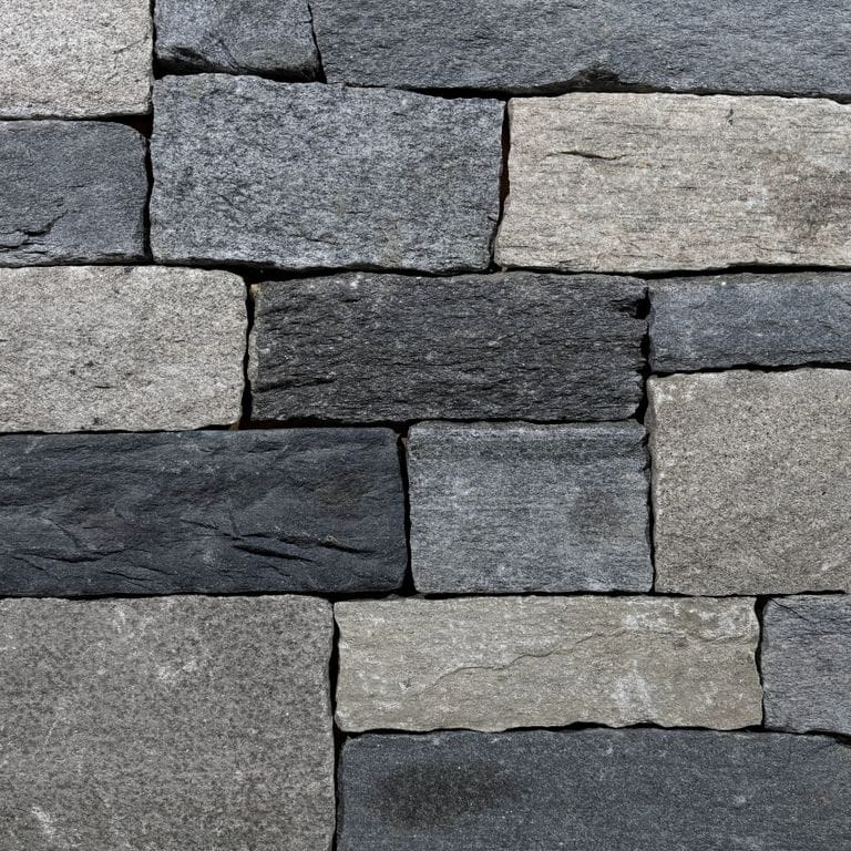 Color/Finish variation image for Windsor Granite Thin Veneer. The surface finish shown is split-face. Dominant colors shown are black and gray. The color mix creates a cool feeling.