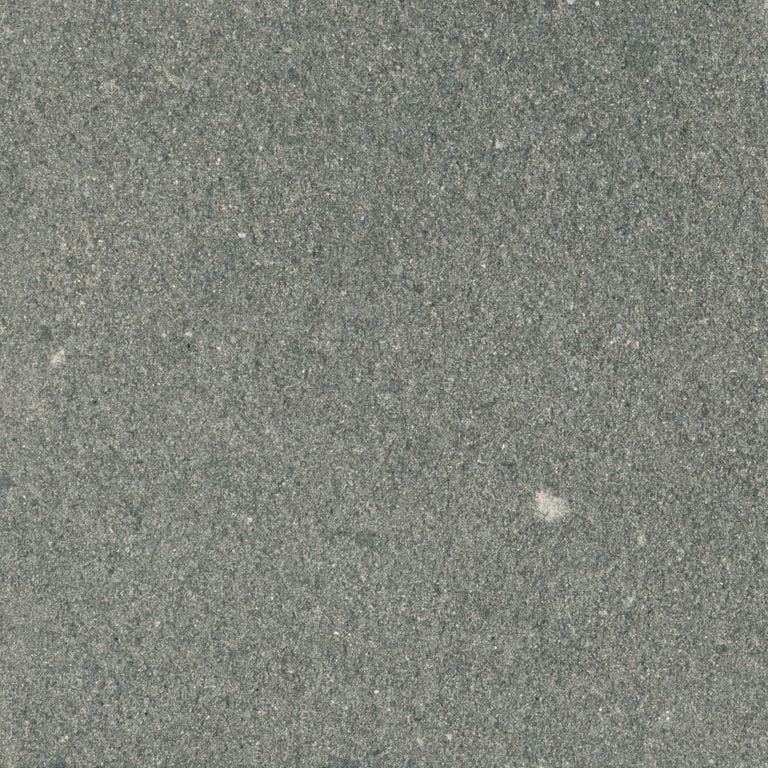 Feature image for Tobacco brown sandstone. The surface finish shown is sand blasted. Dominant colors shown are green and gray. The color mix creates a cool feeling. Solid color pattern.