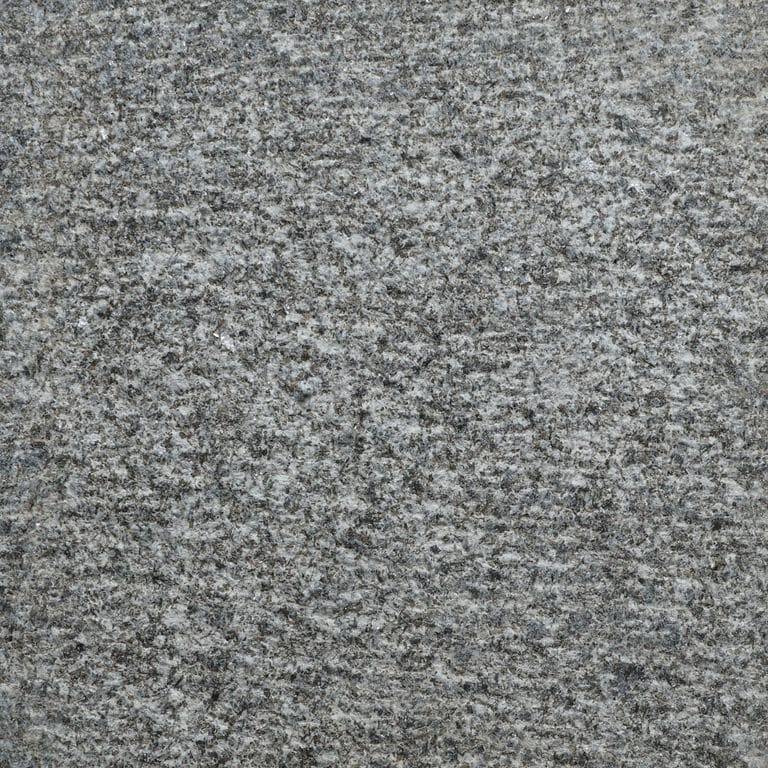 Color/Finish variation image for Pensy Black Granite. The surface finish shown is adze. The dominant color shown is gray. The color mix creates a cool feeling.