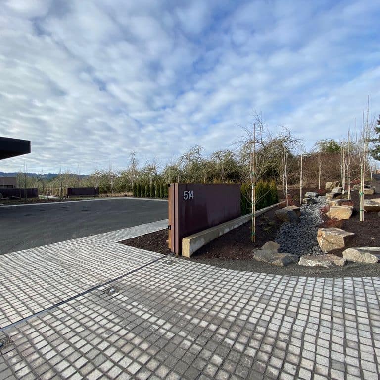 Application image for Granite - Pensy Black. The image shows this material being used in a driveway pavers application. Dominant colors shown are black and gray.
