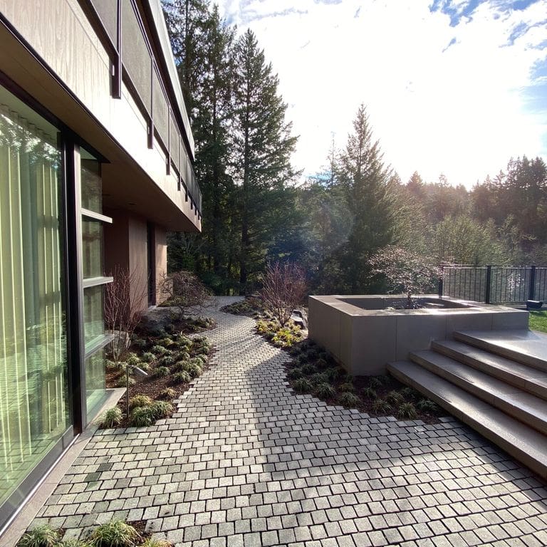 Application image for Granite - Pensy Black. The image shows this material being used in a path pavers application. Dominant colors shown are black and gray.