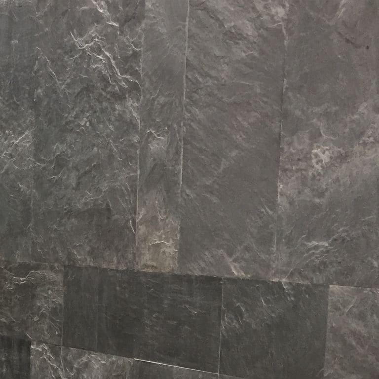 Best close-up image for Slate - Iberian Gray. The surface finish shown is natural cleft. Dominant colors shown are black, brown and gray. Exhibits "movement". Streaked and marbled color patterns.