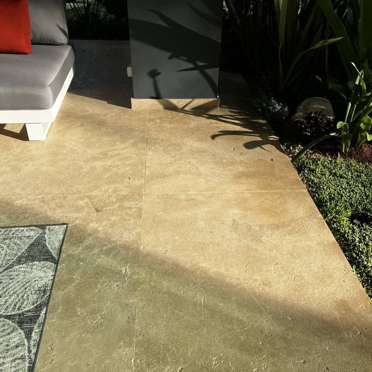 Best close-up image for Limestone - Rabat Beige. The image shows this material being used in a patio pavers application. The surface finish shown is brushed. Dominant colors shown are gray, orange/rust and tan. The color mix creates a warm feeling.
