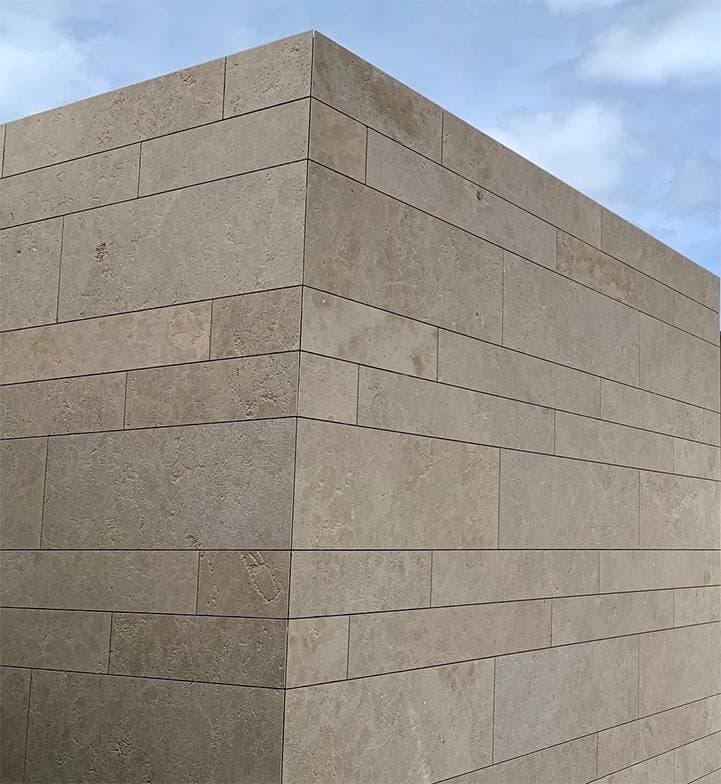 Application image for Rabat Beige Limestone. The image shows this material being used in a full bed veneer application. The surface finish shown is brushed. Dominant colors shown are beige and tan. The color mix creates a warm feeling.