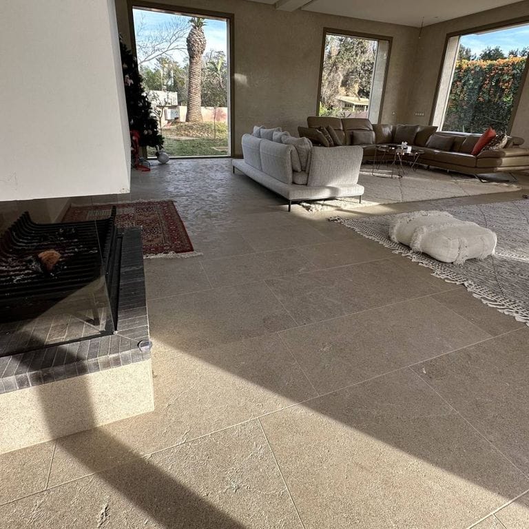 Application image for Limestone - Rabat Beige. The image shows this material being used in an interior floor application. Dominant colors shown are brown, gray and tan. The color mix creates a warm feeling.