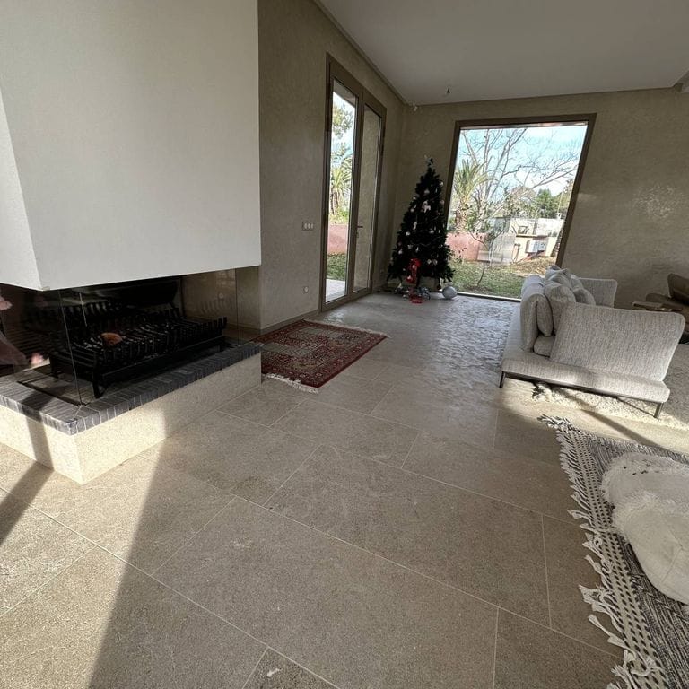Application image for Limestone - Rabat Beige. The image shows this material being used in an interior floor application. Dominant colors shown are gray and tan. The color mix creates a warm feeling.