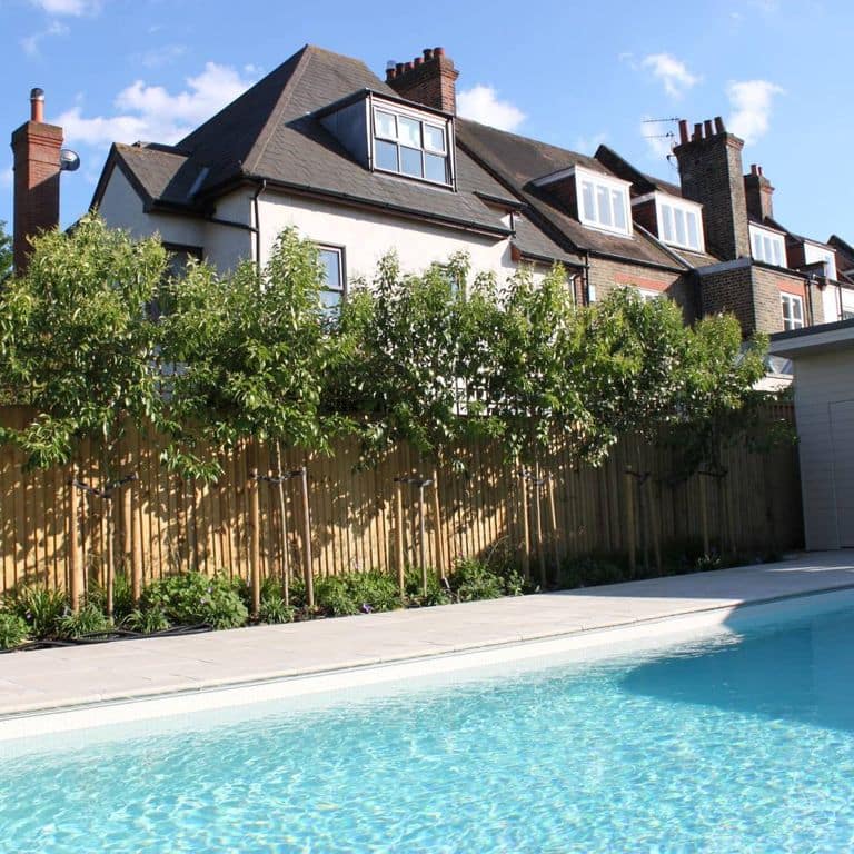 Application image for Limestone - Meknes Beige. The image shows this material being used for pool coping and pool deck pavers. Dominant colors shown are beige and gray. The color mix creates a warm feeling.