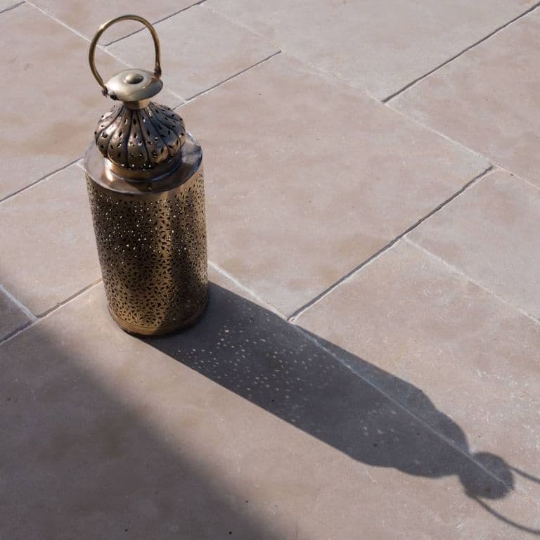 Application image for Limestone - Meknes Beige. The image shows this material being used in a patio pavers application. Dominant colors shown are beige, gray and tan. The color mix creates a warm feeling.