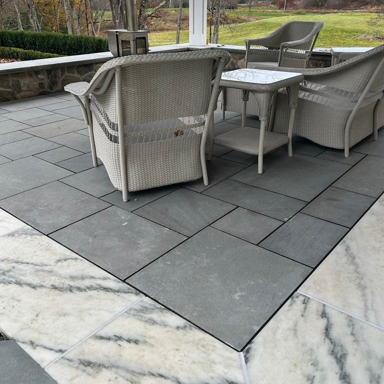 Application image for Marble - White Cloud. The image shows this material being used in a patio pavers application. Dominant colors shown are gray and white. The color mix creates a cool feeling.