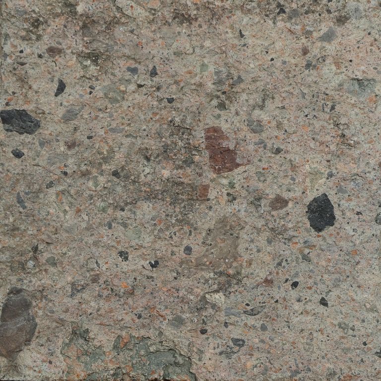 Color/Finish variation image for Reclaimed Tuff Stone. The surface finish shown is split-face. Dominant colors shown are brown and gray. The color mix creates a warm feeling.