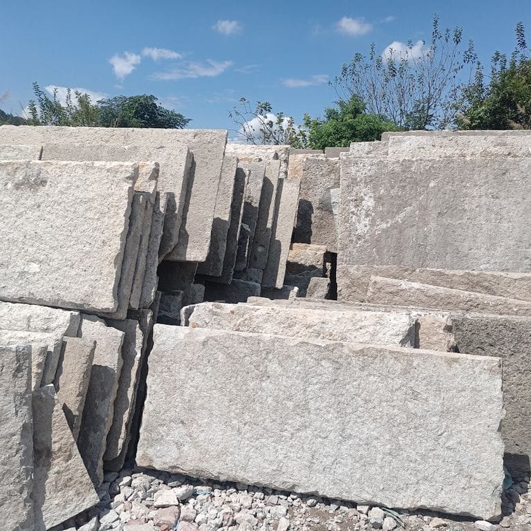 Feature image for Reclaimed Porphyry Oversized Pavers. The dominant color shown is gray; with beige, brown, green, purple, white and cream secondaries. The color mix creates a warm feeling. Regular, fine speckled and speckled color patterns.
