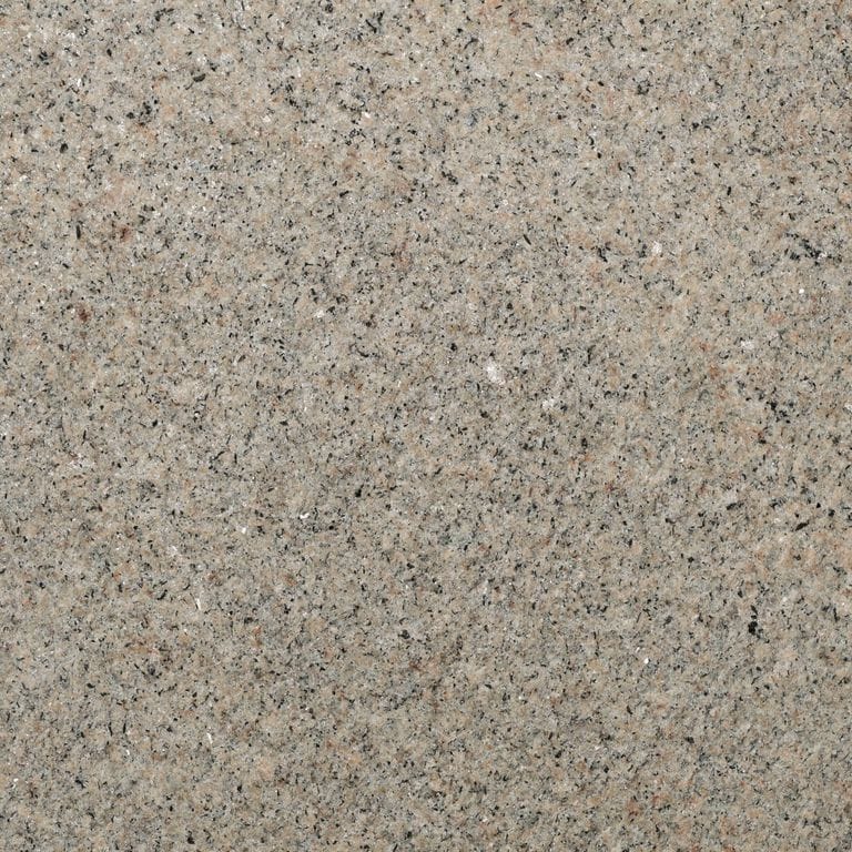 Feature image for Camden Tan Granite. The surface finish shown is flamed. Dominant colors shown are gray and tan; with beige, orange/rust and purple secondaries. Exhibits "movement" and the color mix creates a warm feeling. Speckled color pattern. Contains mineral inclusions.