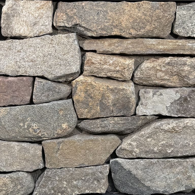 Color/Finish variation image for New England Fieldstone Flats. The surface finish shown is weathered. Dominant colors shown are gray and tan. The color mix creates a warm feeling.