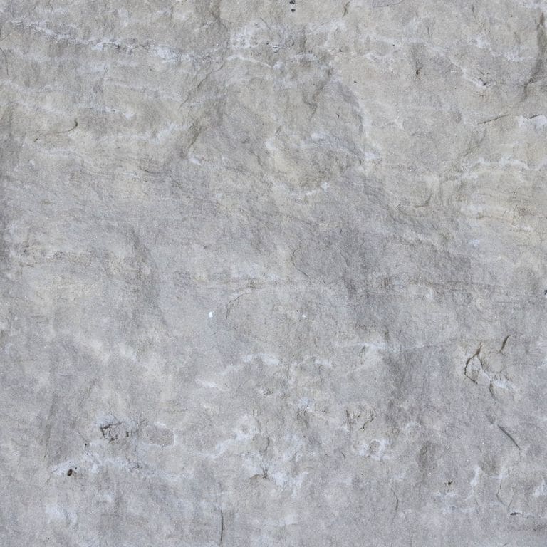 The surface finish shown is split-face. Dominant colors shown are blue, gray and white. The color mix creates a cool feeling. Fine speckled color pattern. Contains some mica.