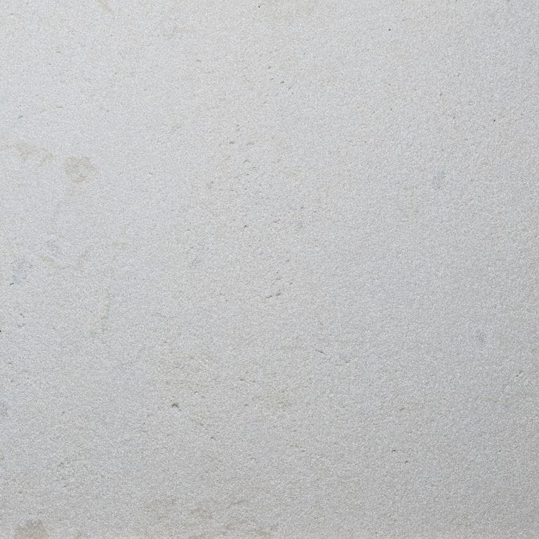Color/Finish variation image for Dovewhite Limestone. The surface finish shown is sand blasted. Dominant colors shown are gray and white. The color mix creates a cool feeling.