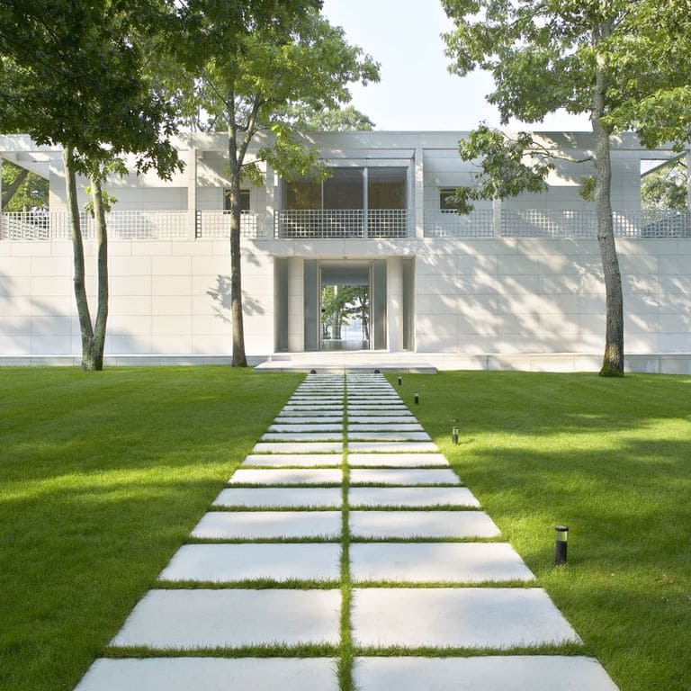 Application image for Dovewhite Limestone. The image shows this material being used for path pavers and full bed veneer. Dominant colors shown are beige and white. The color mix creates a cool feeling.