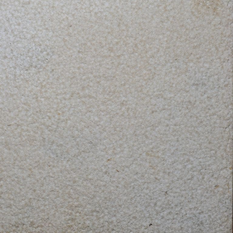 Color/Finish variation image for Buff Limestone. The surface finish shown is bush hammered. Dominant colors shown are gray and tan. The color mix creates a warm feeling.