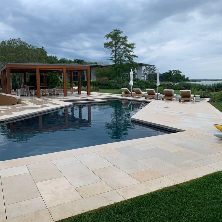 Feature image for Buff Limestone. The image shows this material being used for pool coping and pool deck pavers. The surface finish shown is sand blasted. Dominant colors shown are beige and tan. The color mix creates a warm feeling.