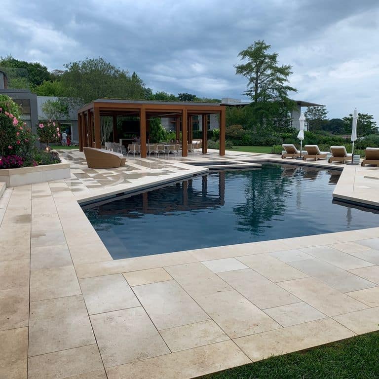 Application image for Buff Limestone. The image shows this material being used for pool coping and pool deck pavers. The surface finish shown is sand blasted. Dominant colors shown are beige and tan. The color mix creates a warm feeling.