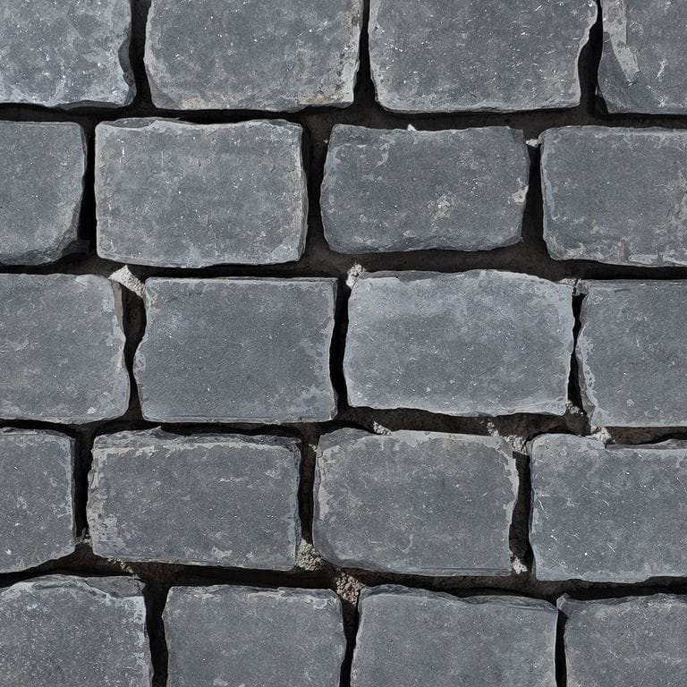 Color/Finish variation image for Reclaimed Basalt Cobblestones. The surface finish shown is flamed. Dominant colors shown are black and gray. The color mix creates a cool feeling.