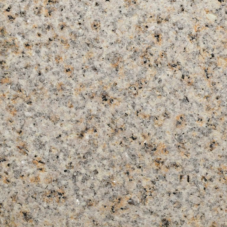 Color/Finish variation image for Amber Granite. The surface finish shown is sand blasted. Dominant colors shown are yellow, tan and cream. The color mix creates a warm feeling. Speckled and coarse speckled color patterns.