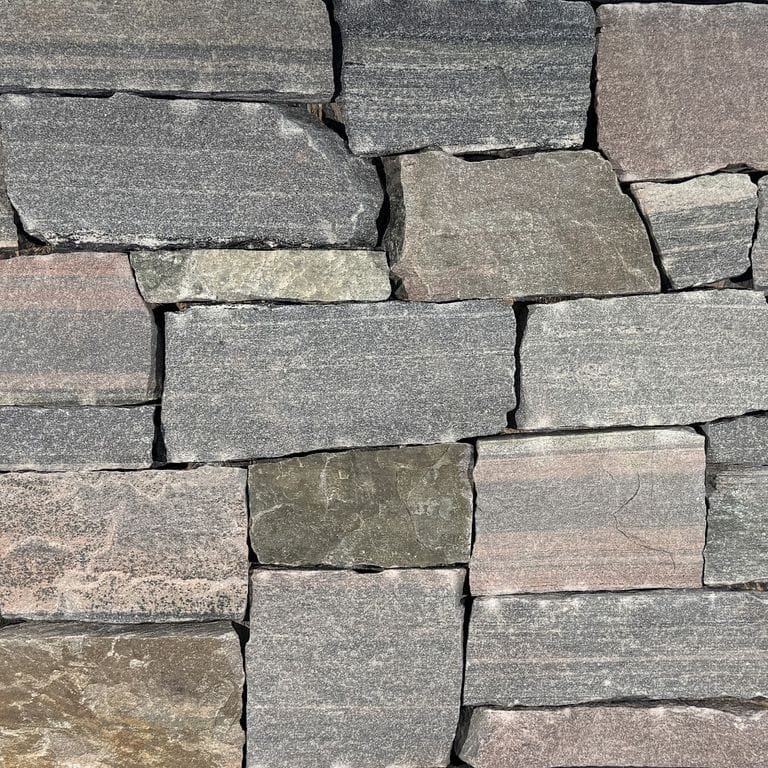 Color/Finish variation image for Mount Von Trapp Granite. The surface finish shown is split-face. Dominant colors shown are gray and pink. The color mix creates a warm feeling.